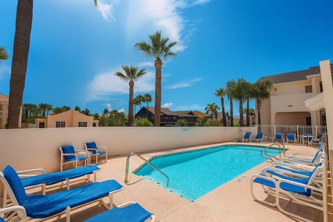 Unwind poolside under palm trees at Sea Dancer #1! This inviting retreat features plenty of sun loungers, a sparkling pool, and peaceful tropical vibes. Ideal for relaxing after beach adventures or enjoying quiet afternoons with loved ones.
