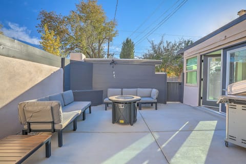 Private courtyard with modular sectional, fire pit, and gas grill.