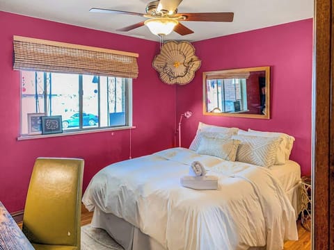 The pink bedroom features a charming and cozy design, with soft hues and stylish decor creating a warm and inviting atmosphere for a restful stay.