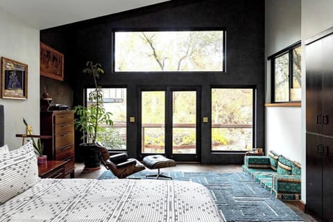 Master bedroom with river view, double shower, balcony, and electric blinds.