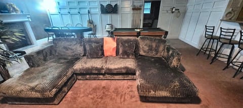 Relax in the living room — new deep-seat sectional, smart TV & fireplace