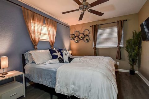 Master bedroom featuring a king bed, large smart TV, dresser, and spacious closet for ultimate comfort and convenience. #MasterRetreat #ComfortableStay #LargoLiving