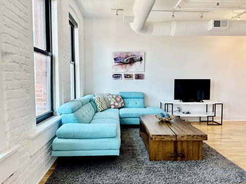 Spacious living room with ample seating and TV