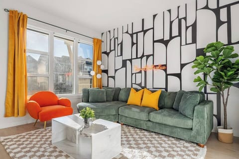 Step into our bright and spacious living room.  With its chic wallpaper and inviting atmosphere, it's the perfect space to relax with your loved ones.