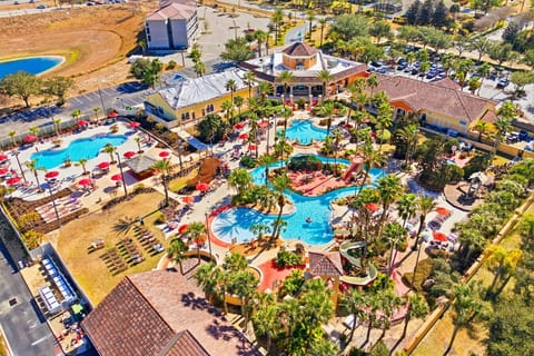 Stunning resort-style pool area with multiple pools, waterslides, and relaxing lounge spaces.