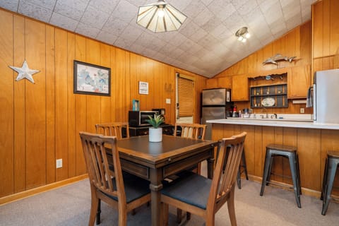 The mid-century table extends to seat 6 and the bar seats 3.