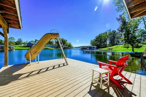 Unwind by the lakeside fire pit, surrounded by stunning water views and outdoor amenities for a perfect retreat.