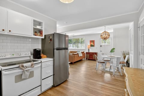 Cook, dine, and relax with ease — this open kitchen and living area makes time together effortless and comfortable.
