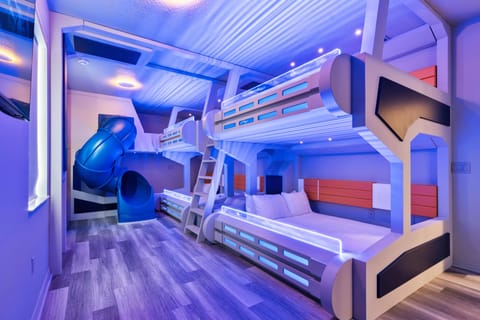 - Futuristic bunk bed room with glowing LED accents  
- Built in slide adds adventure to this kids space  
- Perfect family rental near Orlando with themed rooms