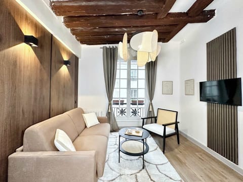 Chic Parisian living room that easily converts to a comfortable second sleeping area