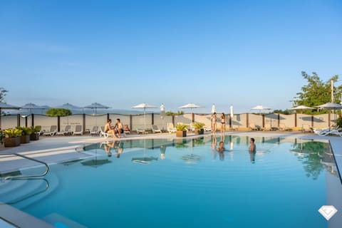 Seasonal outdoor pool, open 10:00 AM to 7:00 PM, pool umbrellas