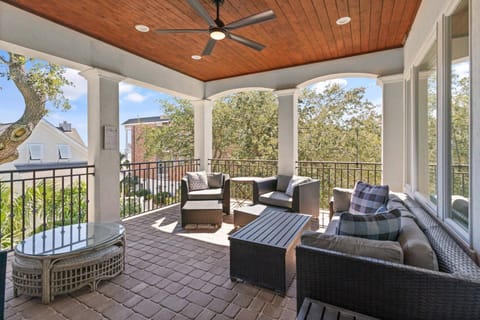 Multiple couches, chairs, and tables make the large covered balcony a perfect place to relax or socialize at any time of day.
