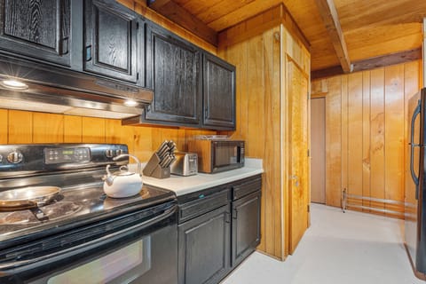 Kitchen. Stove, range, microwave, pantry.