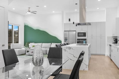 Stylish dining area w/ a modern table setup that flows seamlessly into the kitchen.