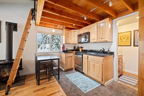 Fully equipped kitchen and dining table seating 4 guests.