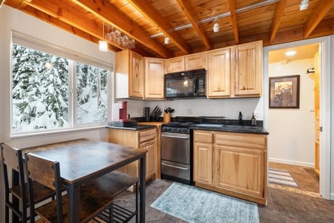 Fully equipped kitchen and dining table seating 4 guests.