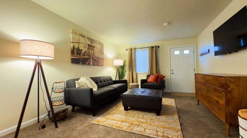 Cozy living room with 60" smart tv.  Board games in tv console.  Black out curtains. 