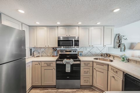 The fully equipped kitchen features updated cabinetry, stainless-steel appliances, granite countertops, and has everything you need to prepare meals for family & friends.