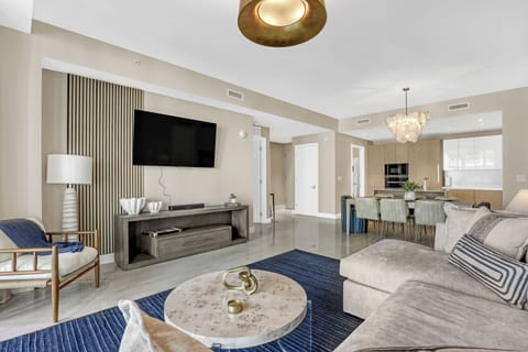 living room with pull out sofa and 65" smart TV