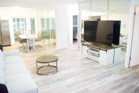 Spacious Living Area with TV and Dining Table
