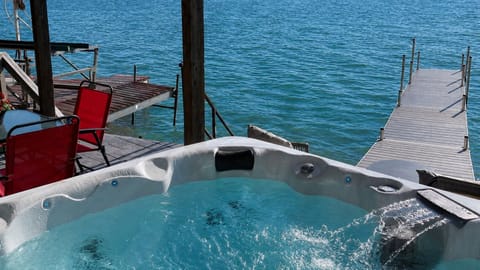Immerse yourself in pure relaxation with our stunning lakefront hot tub. Nestled at the edge of the water, this outdoor haven offers sweeping views of the serene lake and surrounding nature.