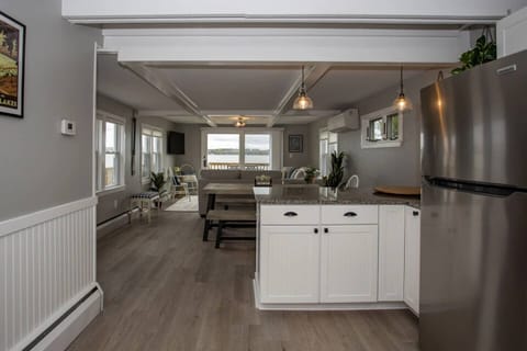 Pendant lighting highlights the elegant simplicity of the space, while a large central island provides both prep space and an informal gathering spot for casual meals. 