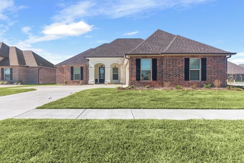 Welcome to Lakes Landing, the best Airbnb in Lake Charles! This pet-friendly home features a charming front view with lush green grass, a spacious garage, and a welcoming ambiance perfect for your next getaway.