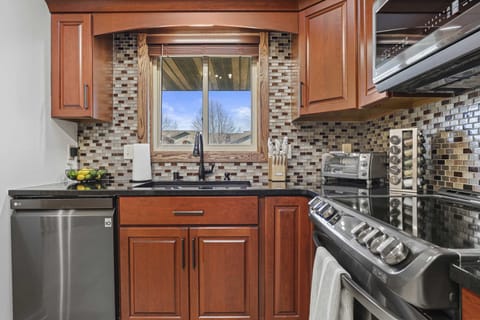 Fully stocked kitchen with granite countertops, coffee station, blender, cookware, toaster oven, and all other necessary cooking items.