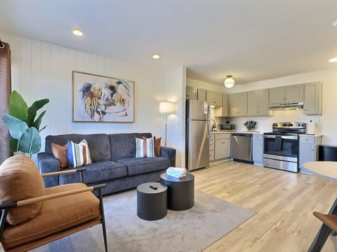 An elegant living area in Downtown Birmingham that blends modern design, natural light, and cozy touches for the perfect stay.