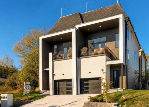 Modern home with covered balconies, stylish design, and great curb appeal.