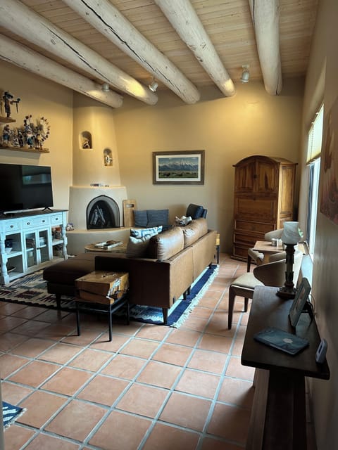 Living room has comfy seating and a gas kiva fireplace for chilly fall & winter!