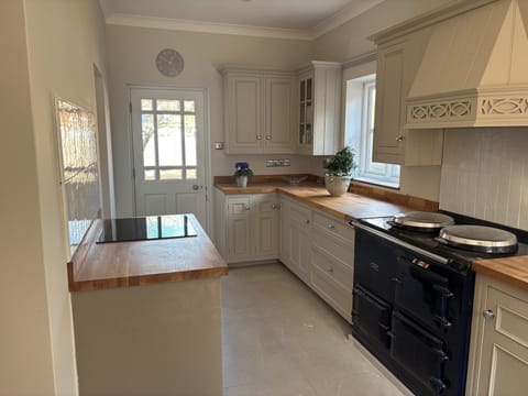 Kitchen with AGA and separate convection hob and electric oven.
