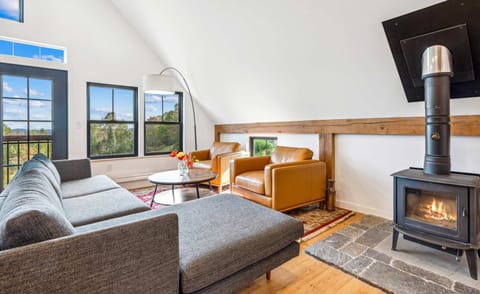 Upstairs living room with a wood-burning stove and valley views