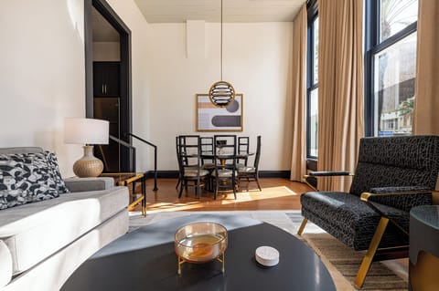 A bright, inviting dining and living area with floor-to-ceiling windows framing a stunning city view.