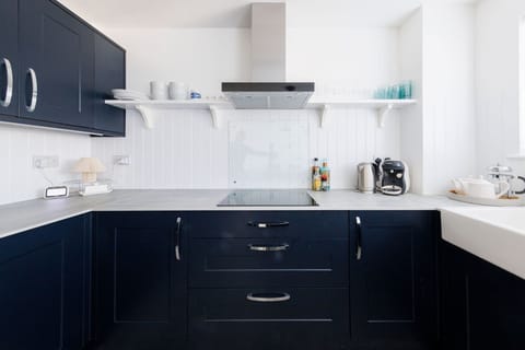 Fully equipped kitchen with induction cooktop and essentials