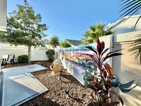 Private, Enclosed Backyard with Captivating Beach-Scene Mural