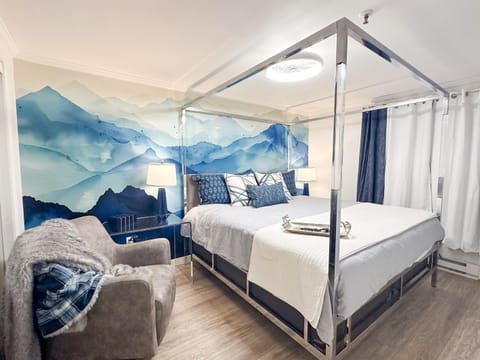 The master KING bedroom is themed for your mountain getaway, and features a Casper mattress, designer bed, writing desk, comfy swivel chair, and 55-inch smart TV.