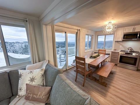 The dining space features a panoramic view of the slopes.