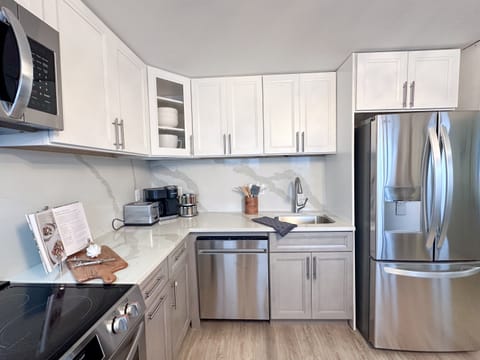 A new kitchen features stainless appliances and is well-stocked for those who want to cook.