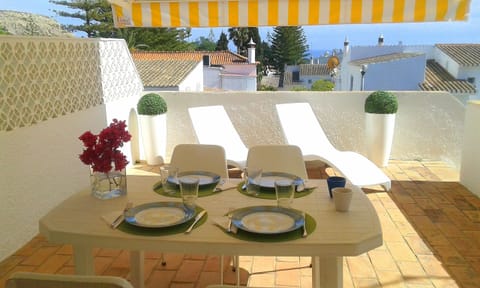Sunshade on the lounge terrace from where steps descend to lower terrace & pool 