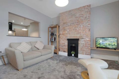 An open-plan living room with indoor fireplace, dining area and kitchen, benefit from a SMART TV with Netflix and plenty of space to sit down and relax. 