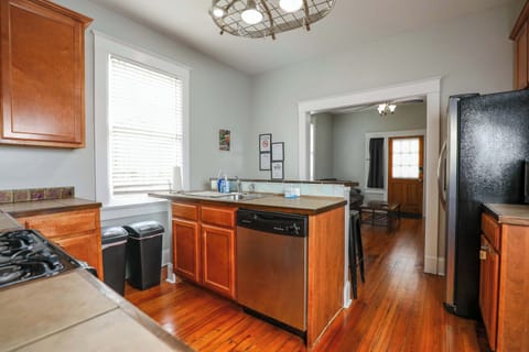 Kitchen featuring a full set of appliances, bar seating at the counter, and all the cookware, dishes, and utensils you could need.