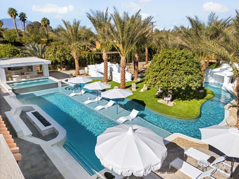 Lazy river pool featuring a waterslide, grotto and multiple waterfalls.