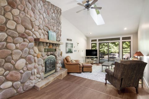 Main living area with gas fireplace, TV, back porch.