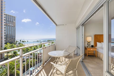 Step onto your private balcony and let the ocean breeze and stunning beach views frame your perfect tropical escape—just steps from your cozy retreat inside.