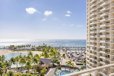This beachfront high-rise offers breathtaking ocean panoramas, with a tropical lagoon, swaying palms, and a vibrant marina stretching out before you—perfect for serene mornings and stunning evenings.