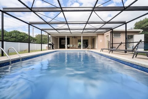 Screened pool, sunny skies, and total privacy 🌴 This vacation rental features a private swim area, lounge chairs, and a grill—perfect for families, groups, or long-term stays. Book your South Florida escape today!