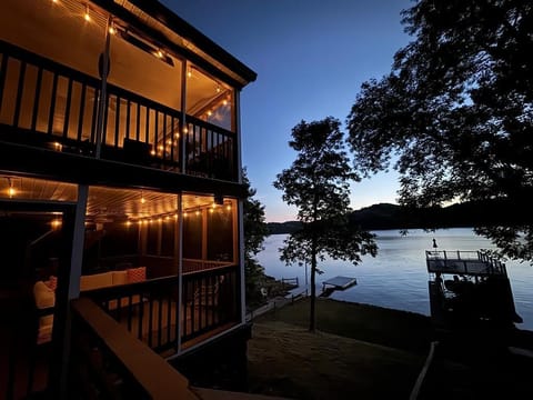 Lakeside escape with a cozy, string-lit porch and stunning sunset views