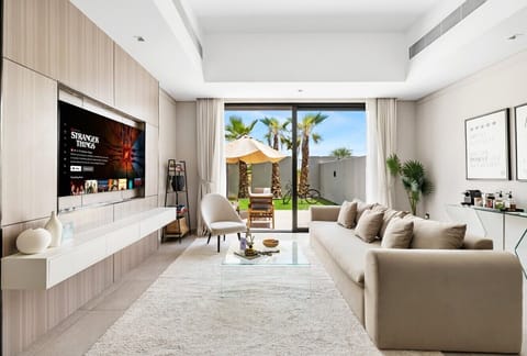 Living room with large TV and garden view