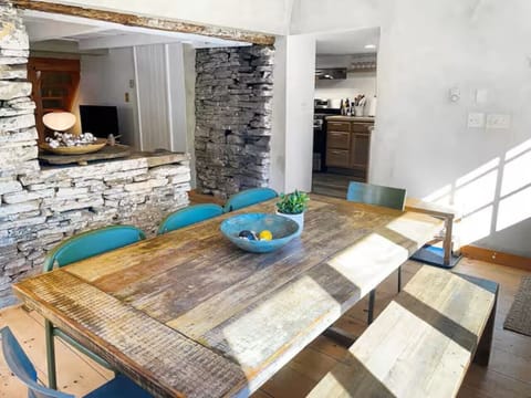 A spacious oak dining table complements the picture window, offering the finest view of the woods.